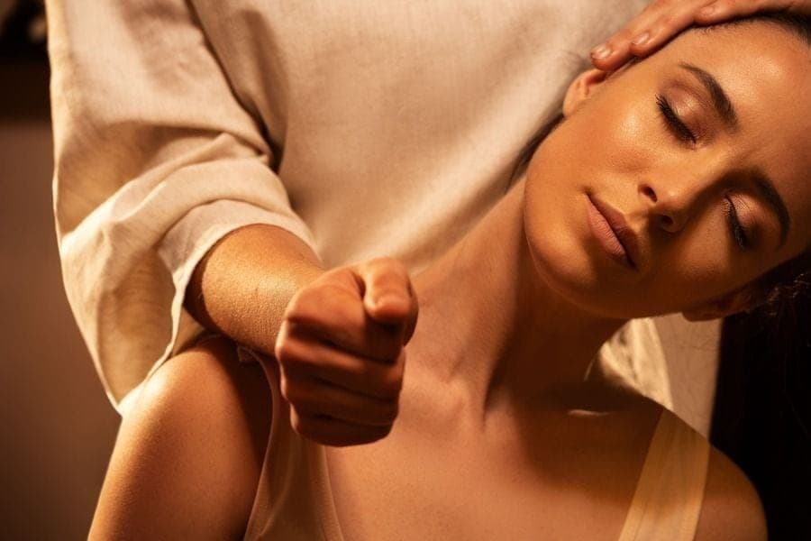 Therapist working on a client's back, neck and shoulders during a focused massage